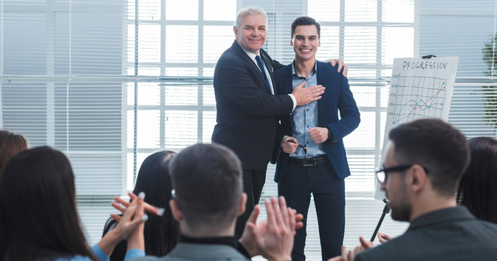 A boss praising their employee for growth and progression in a meeting